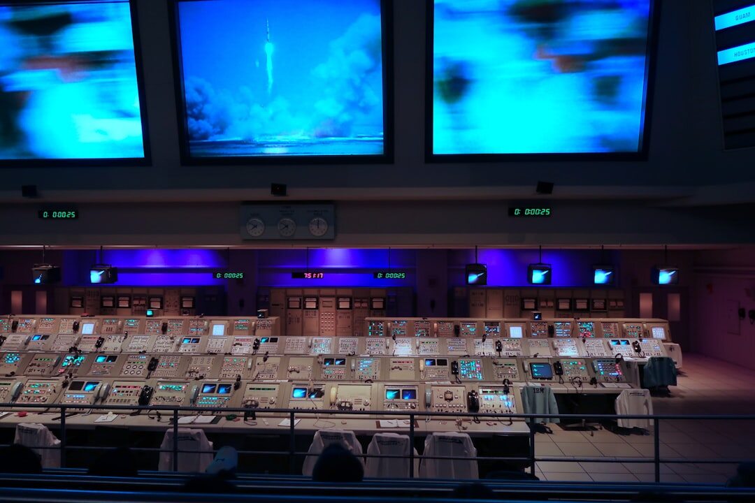 Broadcast control room with multiple video monitors showing camera feeds