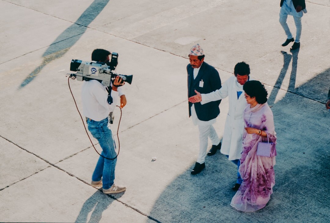 Television field crew filming a multicamera news report outdoors