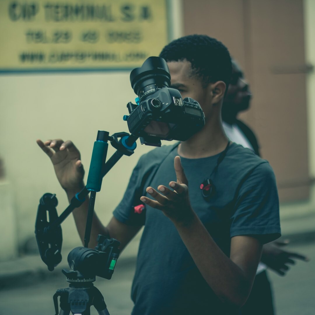 Portrait of a European man in his 40s with camera equipment