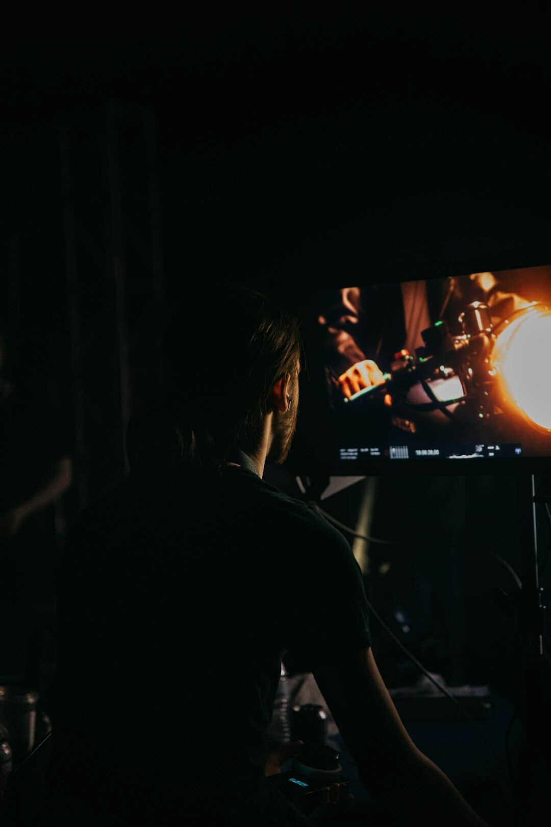 Person analyzing footage on multiple monitors